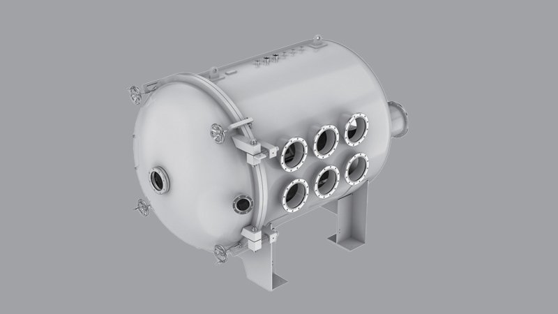 A classic, heavy-duty cylindrical vacuum chamber with thick, domed ends sitting in a university physics laboratory