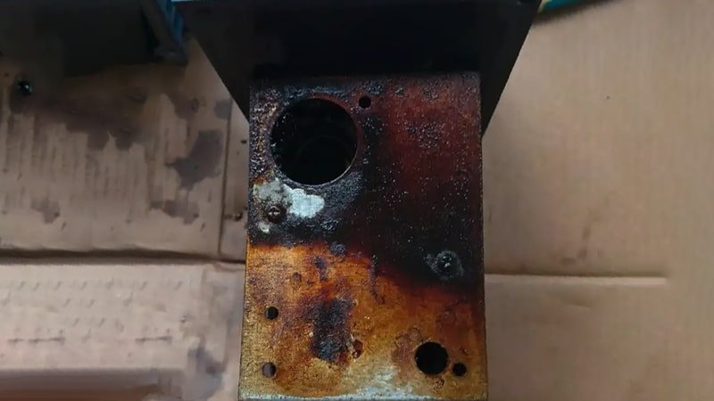 A disassembled vacuum pump on a workbench, with a close-up showing obvious rust and corrosion on the internal steel rotor and vanes