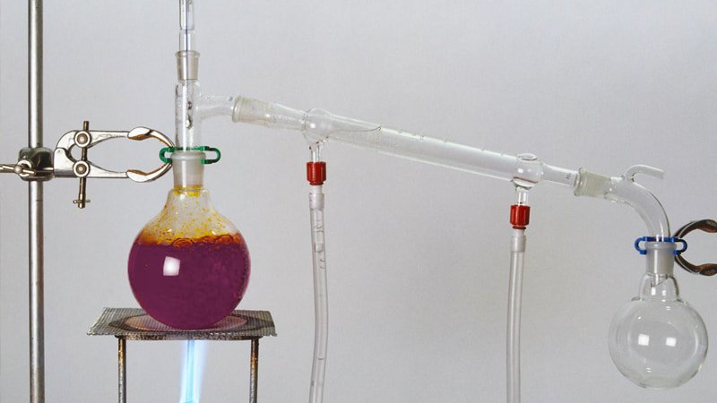 A side-by-side laboratory setup: on the left, a simple distillation apparatus with bubbling liquid; on the right, a vacuum distillation setup with a vacuum pump connected, showing a calmer process
