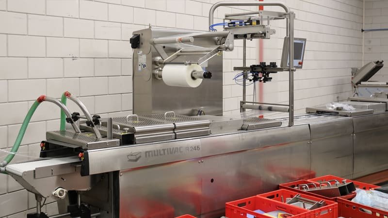 Various types of vacuum packaging machines in a showroom or factory setting